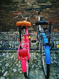 Bicycle parked against brick wall