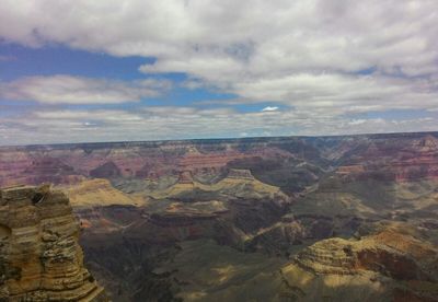 Scenic view of mountains against cloudy sky