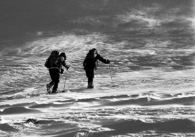 People walking on snow covered land