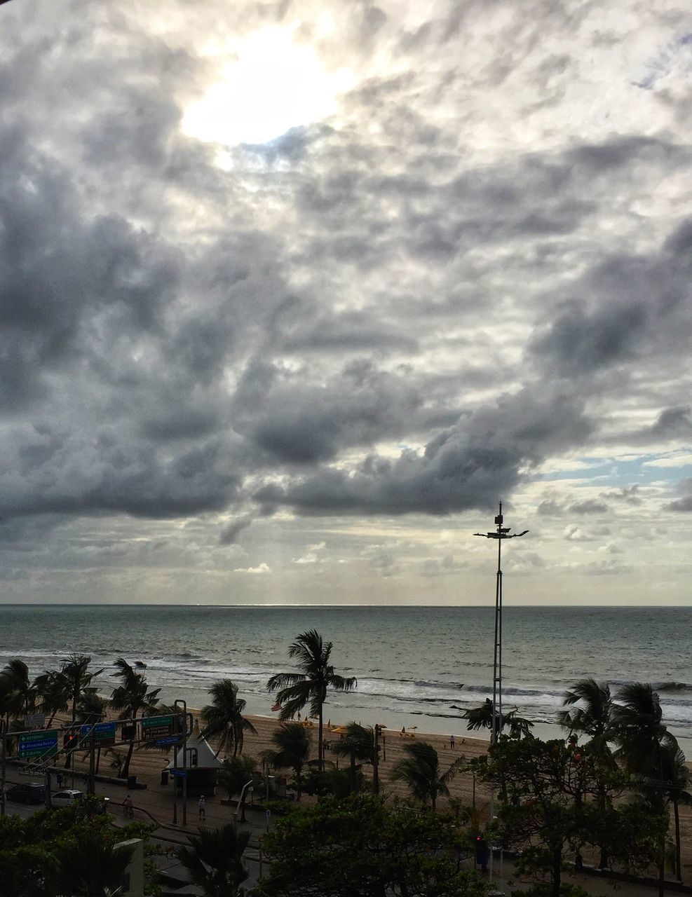 SCENIC VIEW OF BEACH AGAINST CLOUDY SKY