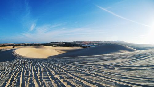 Panoramic view of landscape against blue sky