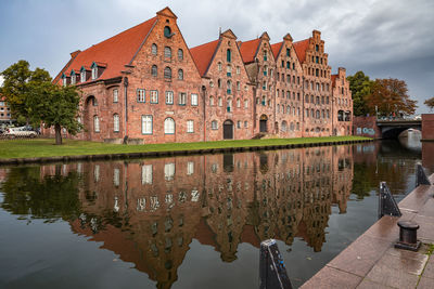 Reflection of building on lake against sky