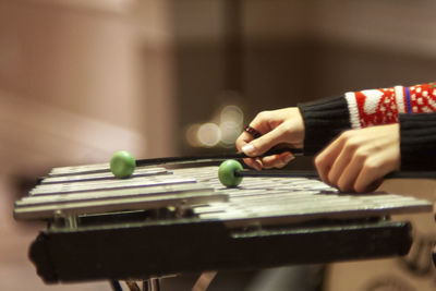 Close-up of boy playing with ball on table