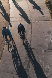 High angle view of people riding bicycle on street