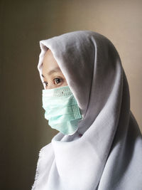 Close-up of young woman wearing mask