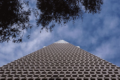 Low angle view of building against cloudy sky