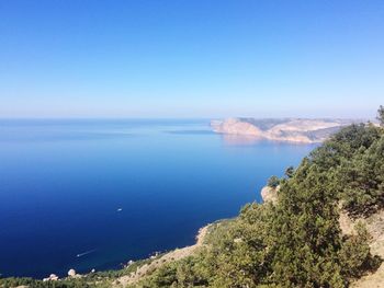 Scenic view of sea against clear blue sky