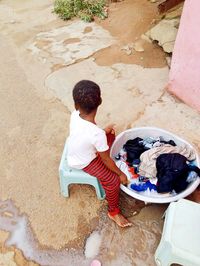 Young girl busy washing clothes.