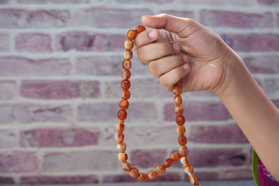 Close-up of hand holding chain