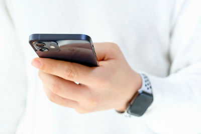 Midsection of man using mobile phone