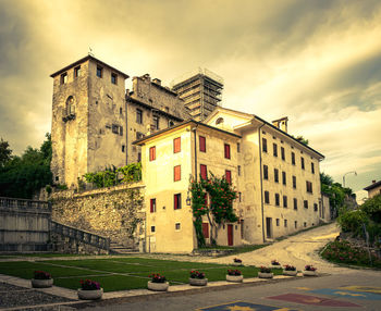 Building by road against sky in city