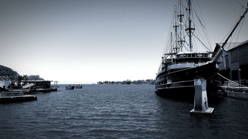 Boats in sea against clear sky