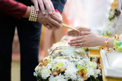 Parents pouring water on bride hands