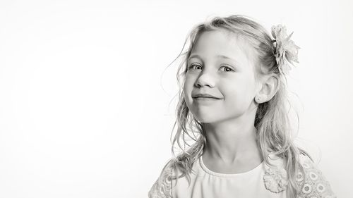 Portrait of smiling girl against white background