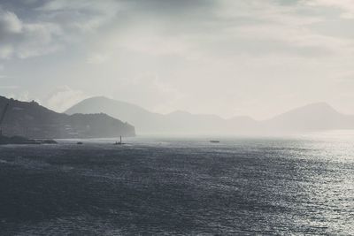 Scenic view of mountains against cloudy sky