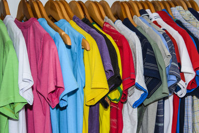 Full frame shot of multi colored clothes hanging on rack at store