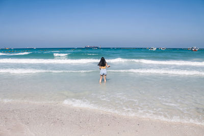 Full length of woman on beach against sky