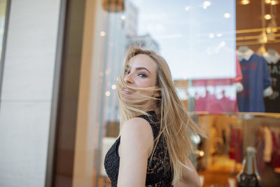 Portrait of young woman in shopping mall