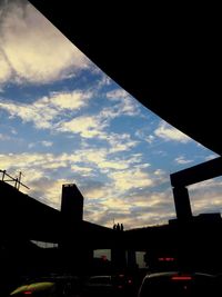 Silhouette city against sky during sunset