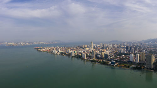High angle view of sea and buildings against sky