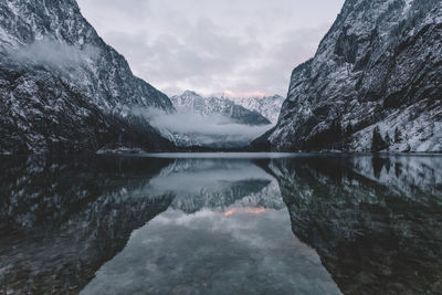 Scenic view of lake and mountains against sky