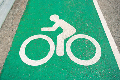 High angle view of bicycle lane sign on road