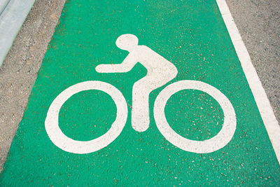 High angle view of bicycle lane sign on road