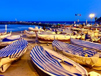 Panoramic view of boats moored on beach against clear blue sky