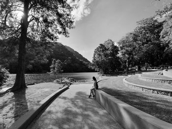 Man walking on road against sky