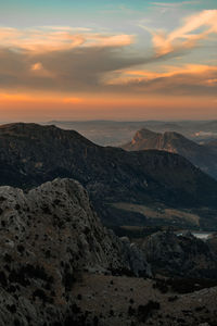 Scenic view of rocky mountains against sky during sunset