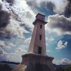 Low angle view of lighthouse against cloudy sky