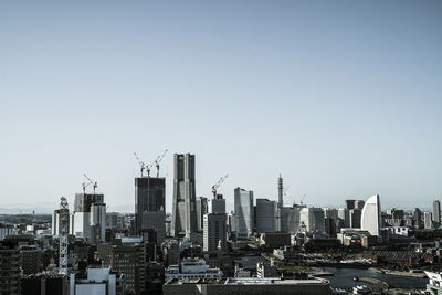 Modern buildings in city against clear sky