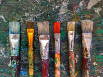 Directly above shot of paintbrushes on table