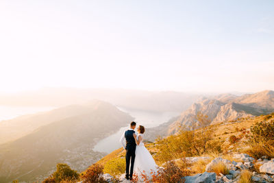 Man standing on mountain against sky