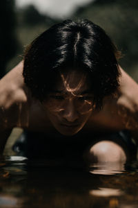 Close-up portrait of a woman in water