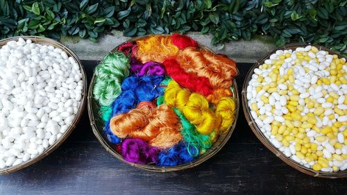 High angle view silkworms and thread in baskets