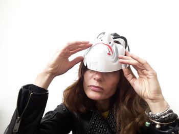 Portrait of woman wearing mask against white background