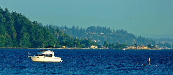 Boat moored on sea against clear sky