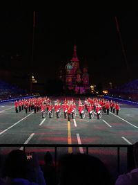 Group of people in front of illuminated building at night