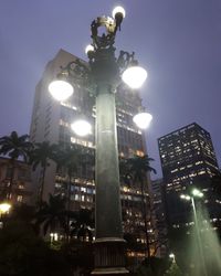 Low angle view of illuminated street light against sky at night