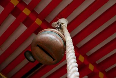 Close-up of a rope with a large copper bell