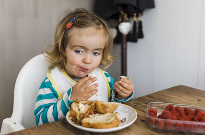 Girl eating breakfast at table