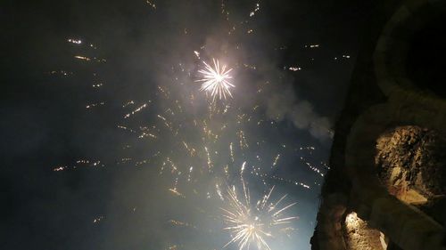 Low angle view of firework display at night