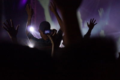 Close-up of silhouette people at music concert