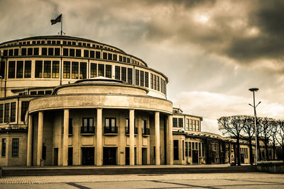 Low angle view of building against cloudy sky