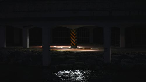 Man in illuminated building against clear sky at night