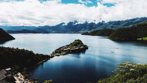 Scenic view of river and mountains against sky