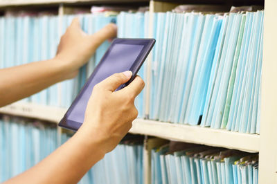 Cropped image of hand holding book