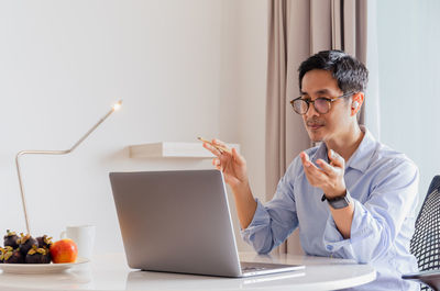 Portrait of businessman having video call on laptop computer