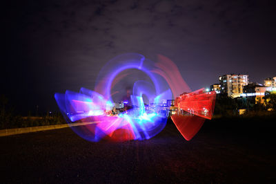 Digital composite image of illuminated light trails in city at night